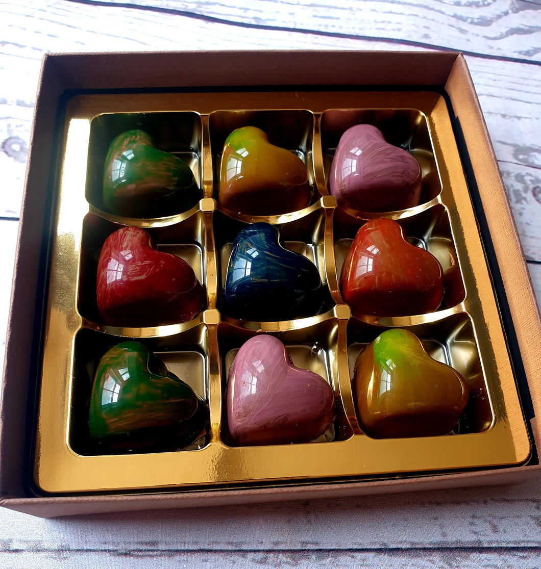Handmade artisan chocolate hearts filled with caramel, in rainbow colours